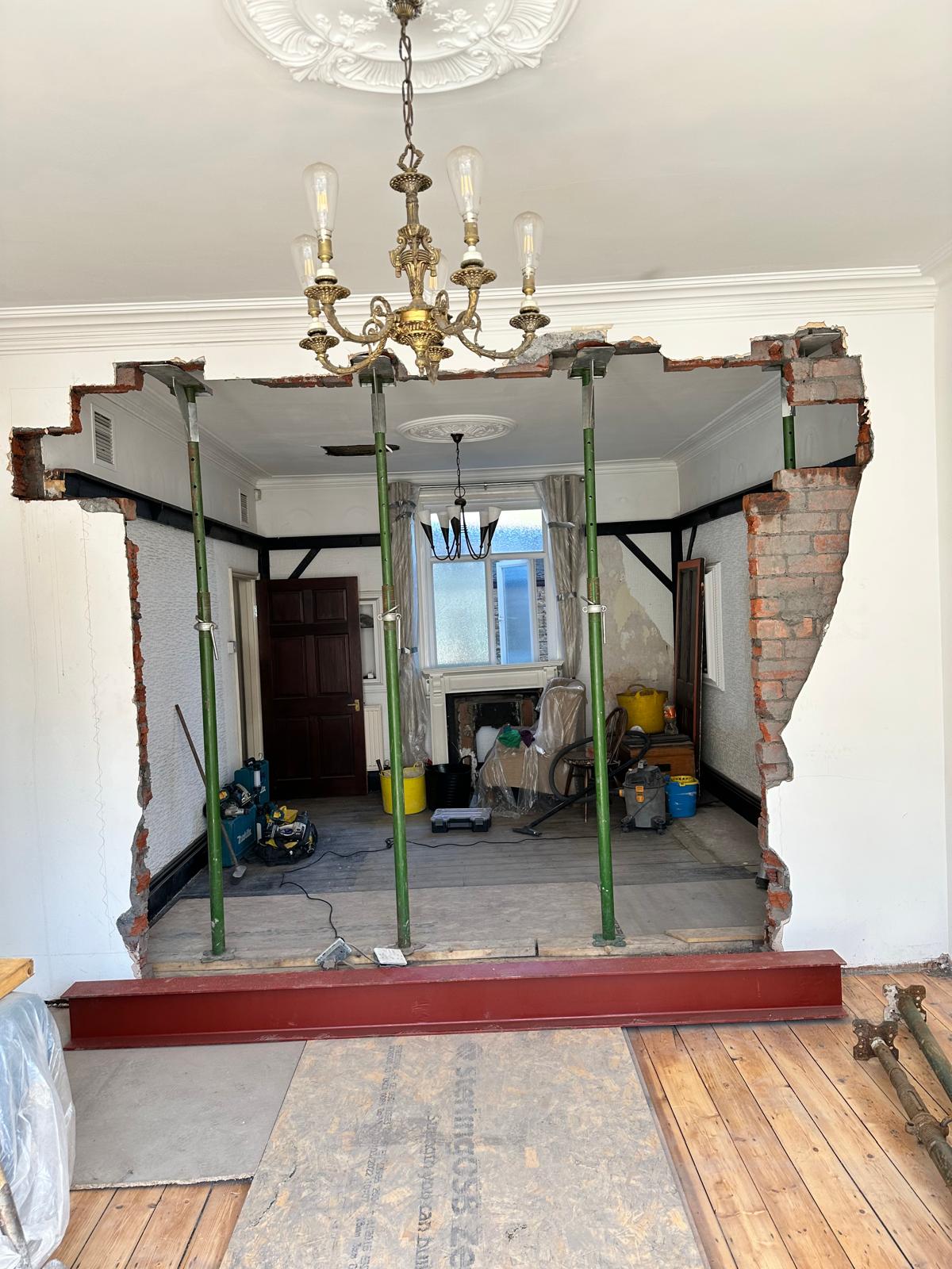 Before: wall propped while the steel goes in