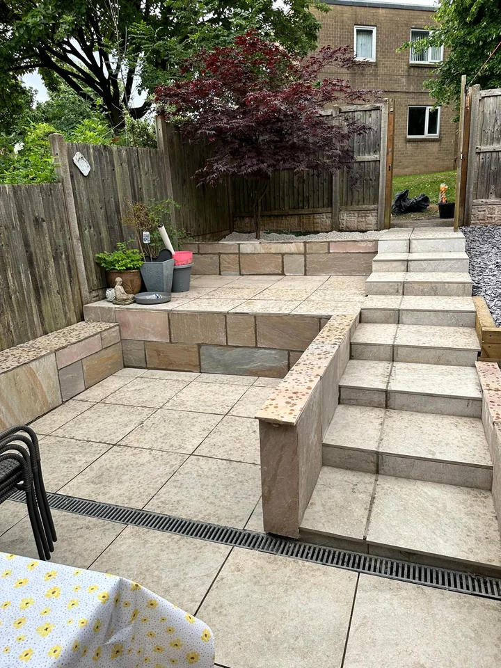 Porcelain patio with steps and raised planters
