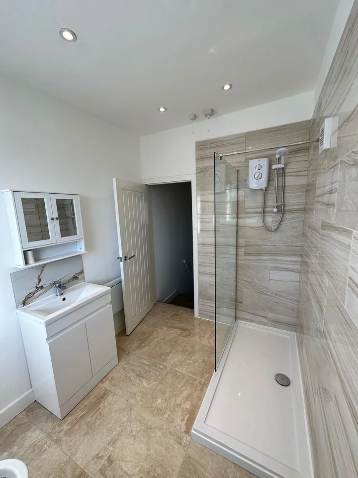 Walk in shower room with glass screen